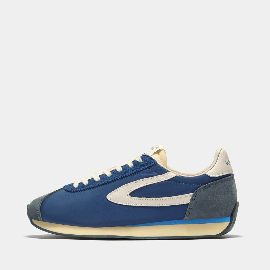 Side view of the London Navy Blue sneaker, showing the refined 1970s Scintilla silhouette and weather-resistant material textures.