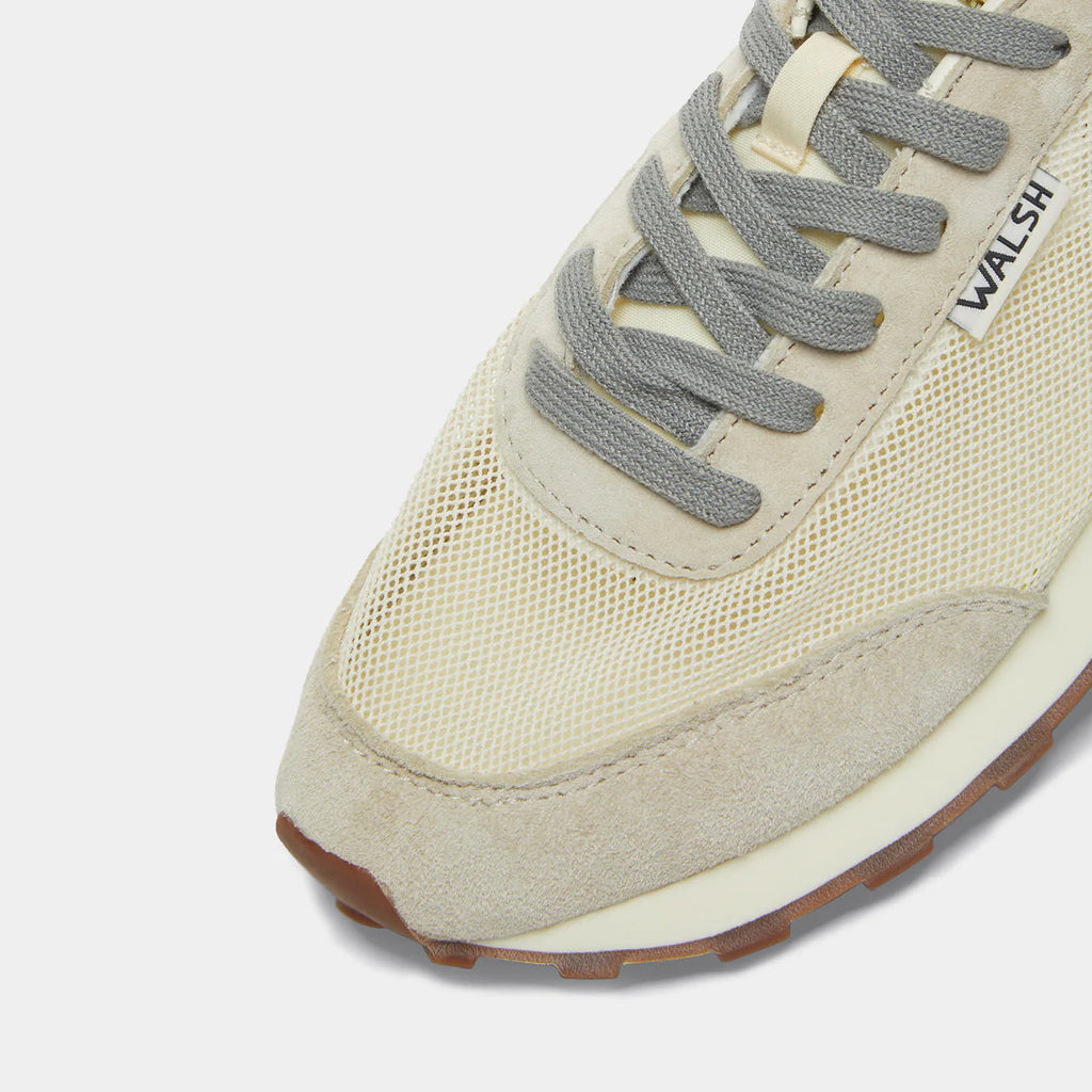 The close-up view of Norman Walsh LA84 Beige & Haze Green — an Olympics-inspired retro runner with mesh upper, EVA cushioning & rubber outsole. 