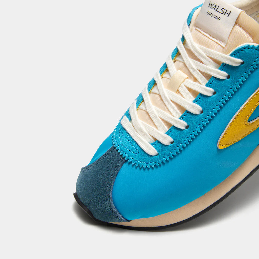 Close-up view of the London Aqua Blue sneaker, showing the refined 1970s Scintilla silhouette and weather-resistant material textures.
