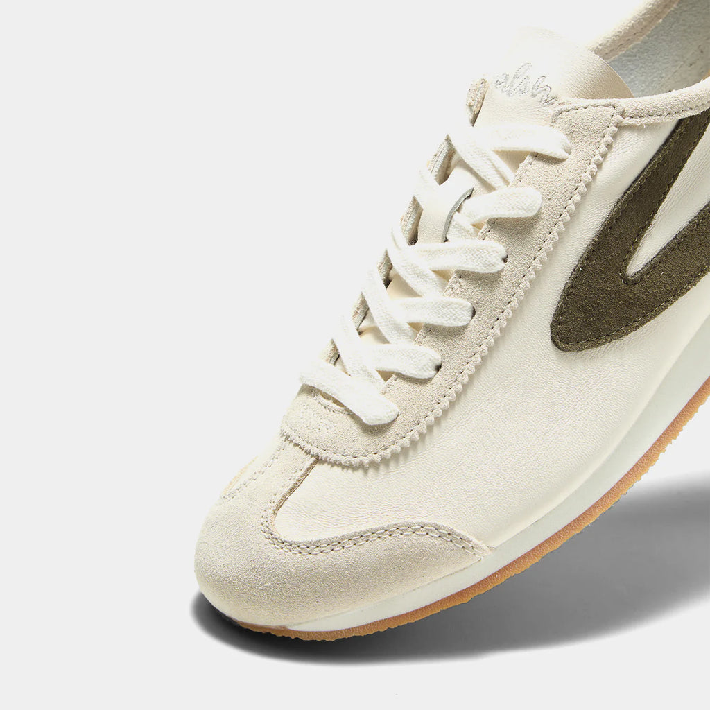 Close-up view of the Norman Walsh sneaker in Beige and Olive Green, featuring premium full-grain leather and suede textures with a durable rubber sole.